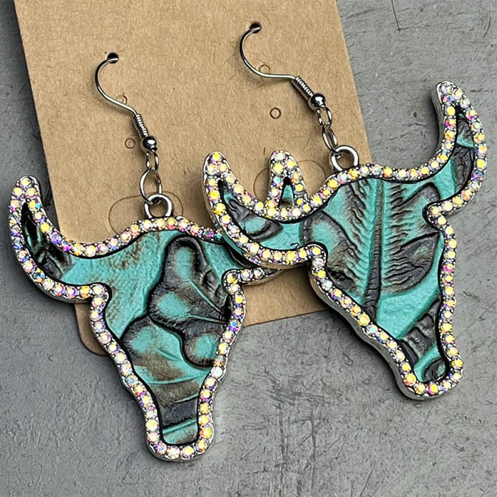 Teal bull skull earrings with crystal trim and embossed detail