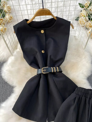 Black belted two-piece set with gold button detail and pockets