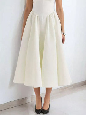Elegant white A-line midi dress with cap sleeves and boat neck, shown with black heels.