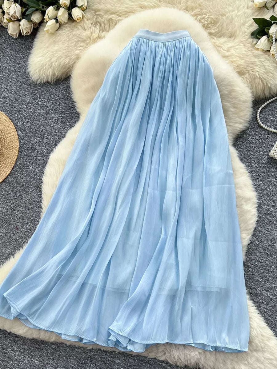 Blue pleated maxi skirt with flowing chiffon fabric and a comfortable waistband.