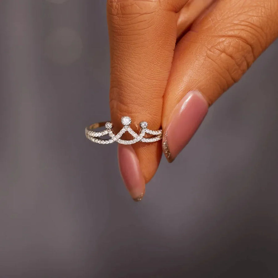 Silver crown motif ring with pave set stones.