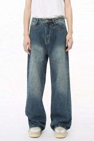 Pleated baggy denim jeans in medium wash with a relaxed fit and wide leg.