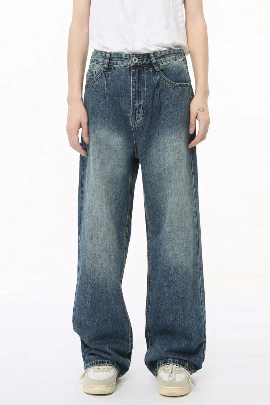 Pleated baggy denim jeans in medium wash with a relaxed fit and wide leg.