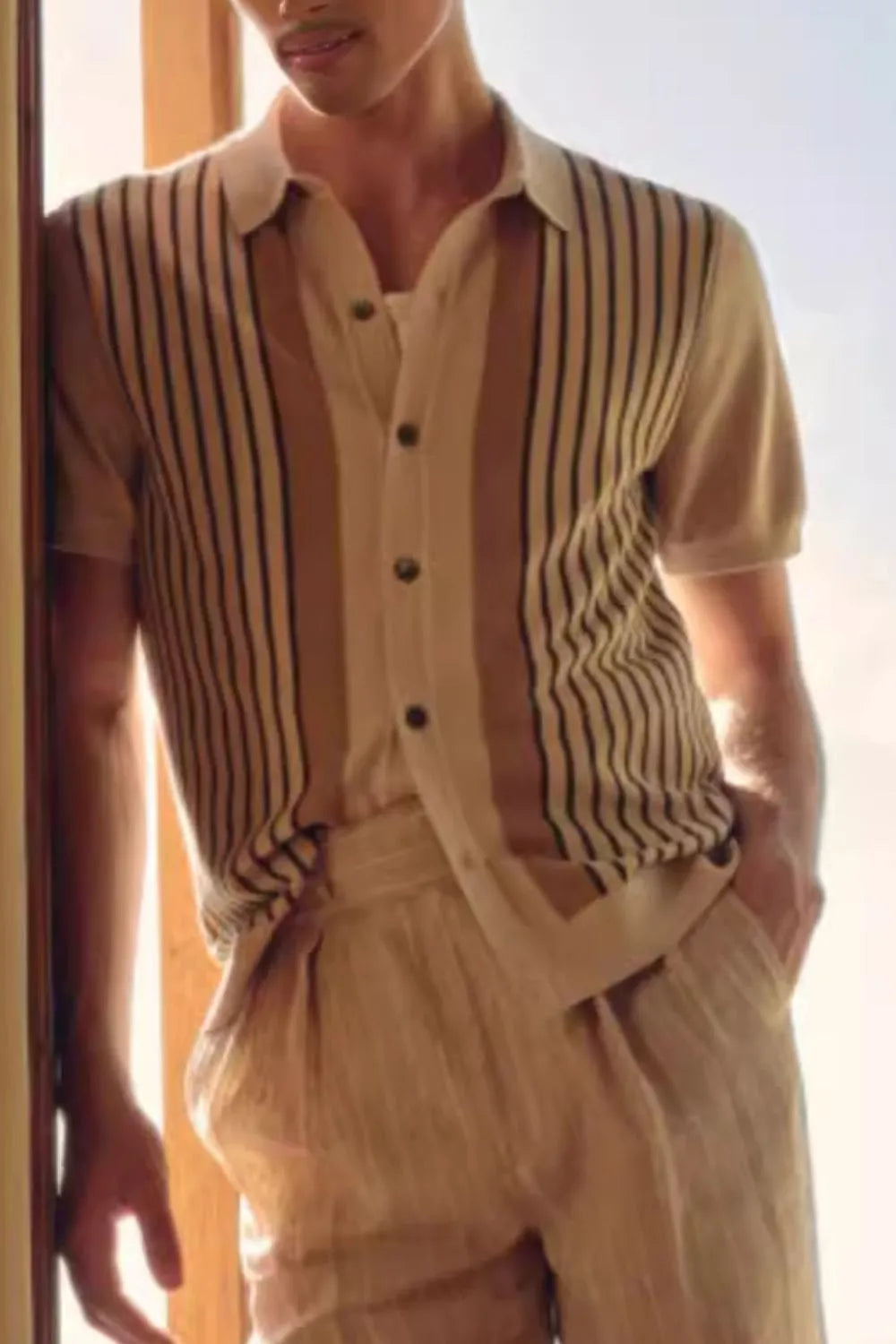 Beige knit polo shirt with vertical stripes and buttoned placket.