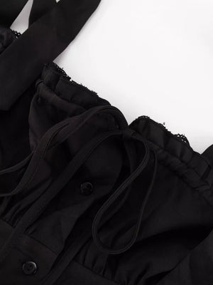 Black ruffled crop top with tie straps and button front detail