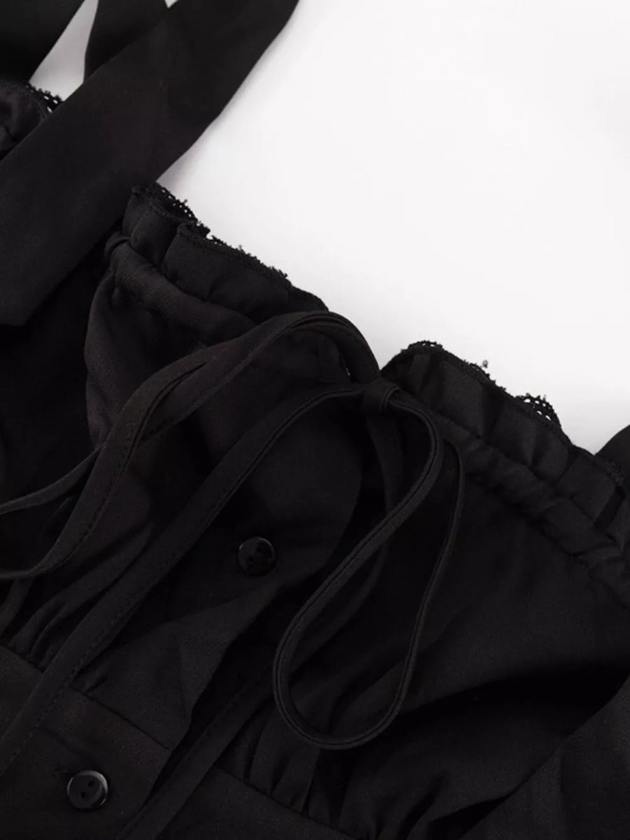 Black ruffled crop top with tie straps and button front detail