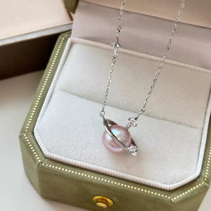 Celestial pearl and silver pendant necklace with delicate star accents.