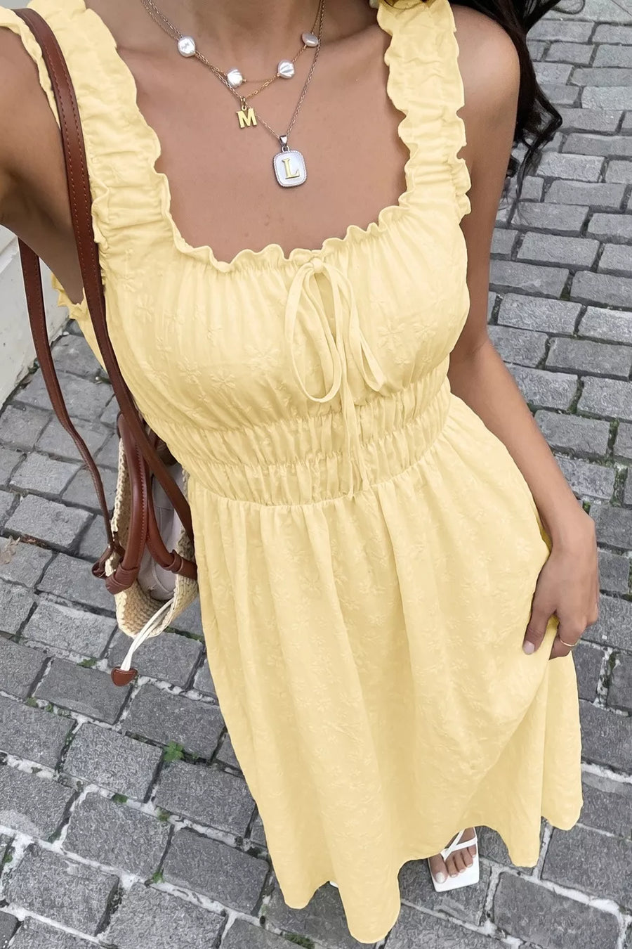 Yellow smocked floral maxi dress with frill straps and tie front detail.