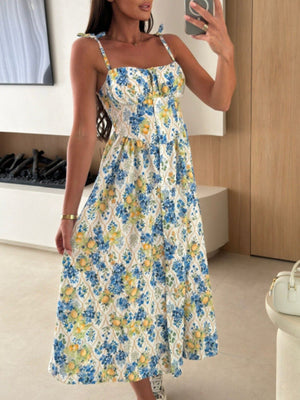 Tie-shoulder midi dress with blue floral and lemon print, sweetheart neckline, and adjustable straps.