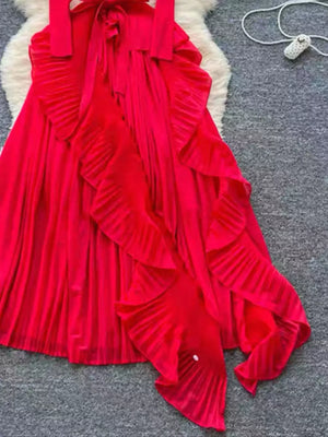 Red midi dress with pleated skirt and cascading ruffles.