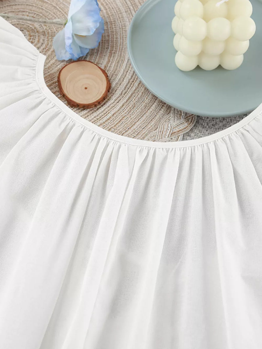 White relaxed mini dress with tie neck
