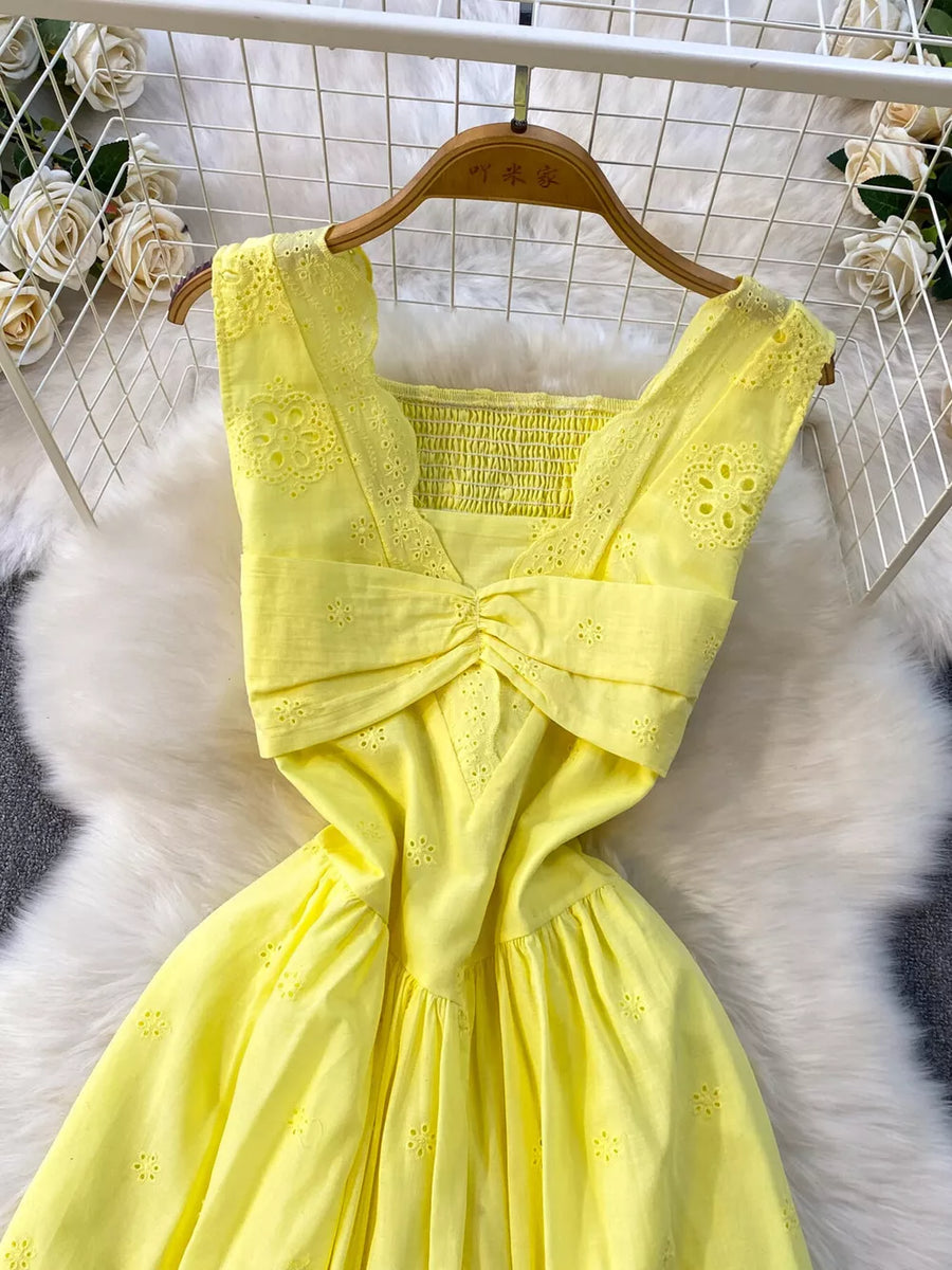 Yellow eyelet maxi dress with smocked bodice, cutout detail and gathered skirt.