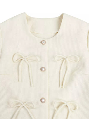 Cream tweed jacket with pearl buttons and tie bows