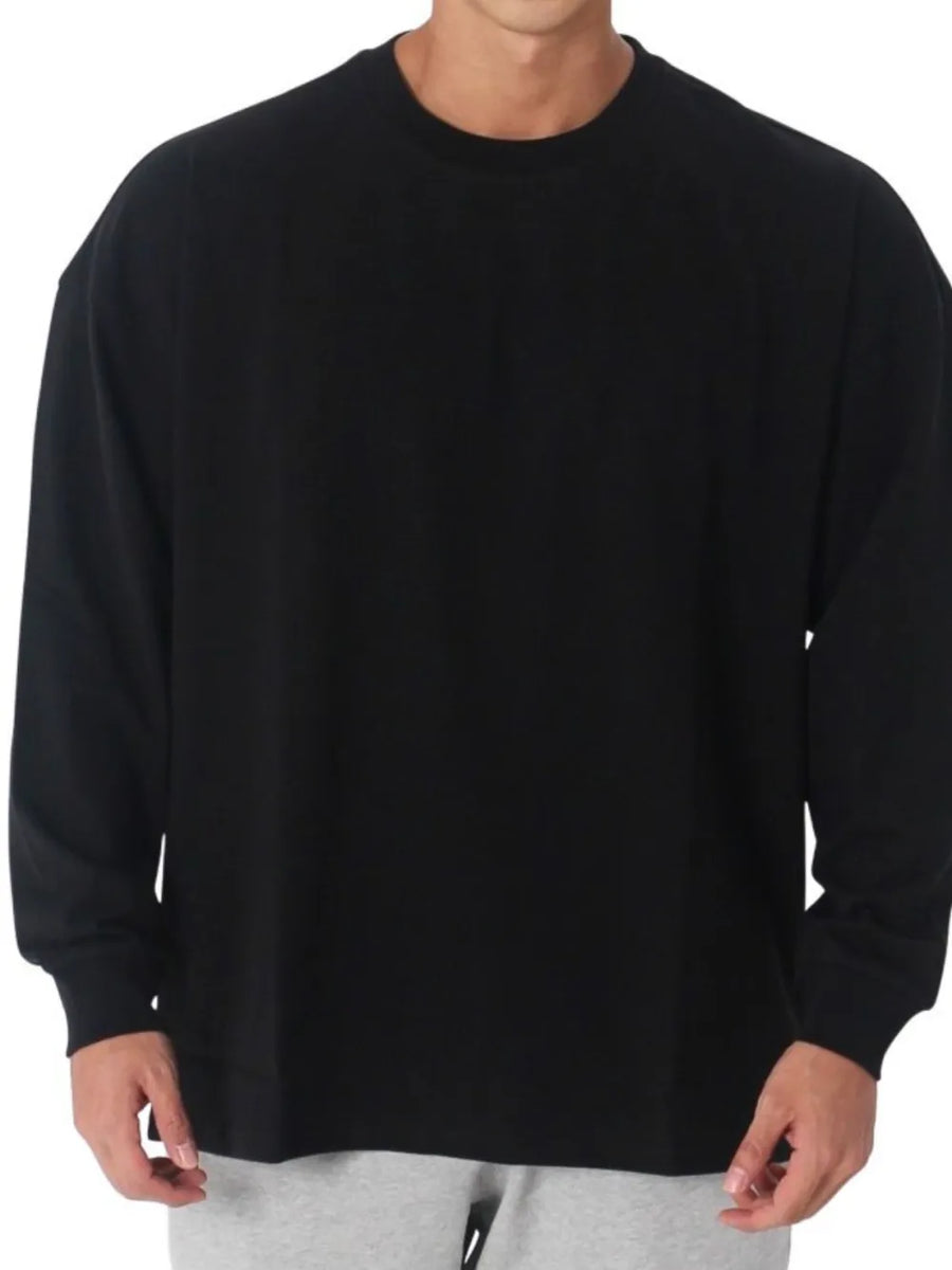 Black oversized crewneck washed cotton tee with long sleeves.