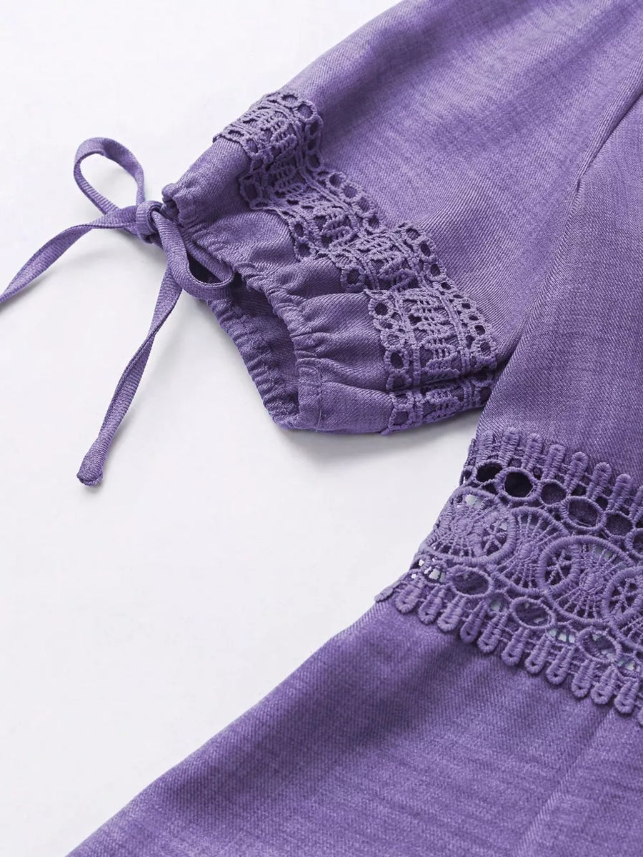 Purple mini dress with lace trim on sleeves and hem, featuring tie details.