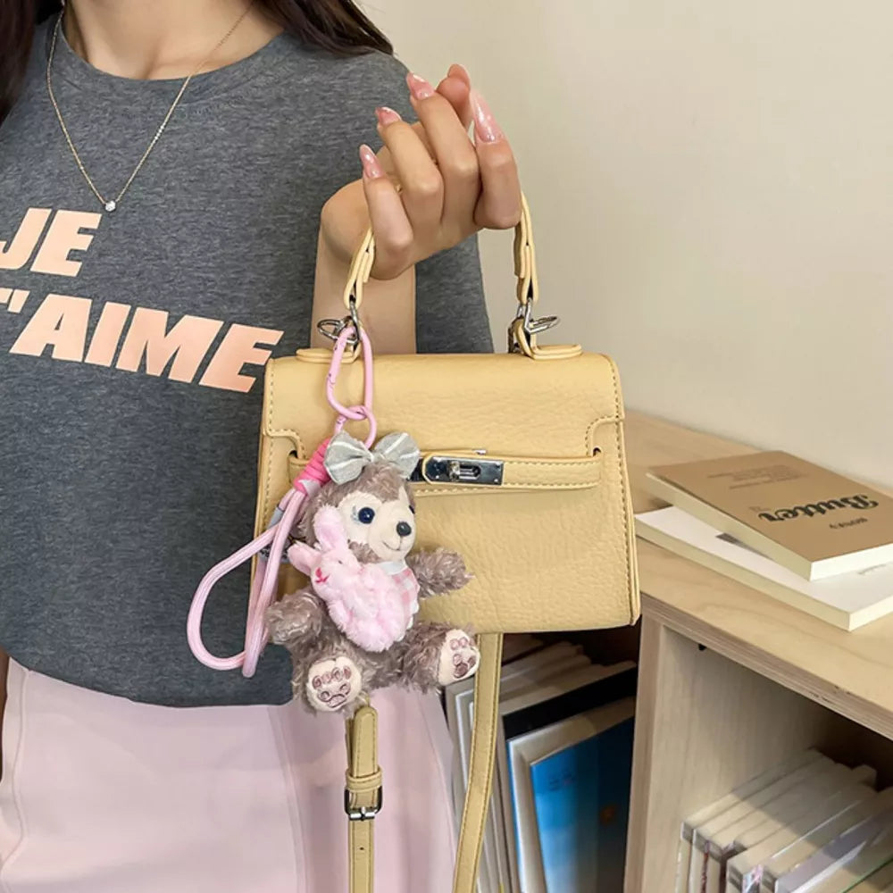 handbag in pale yellow featuring top handle and structured fit