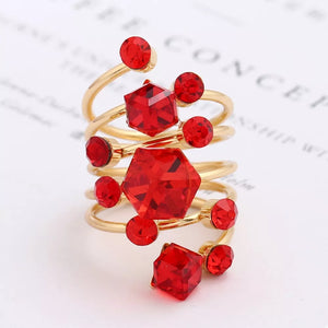 Glamorous multi-layered gold-plated ring with red crystals and hexagonal gems.