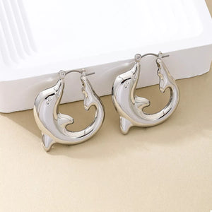Silver dolphin hoop earrings with a polished finish.