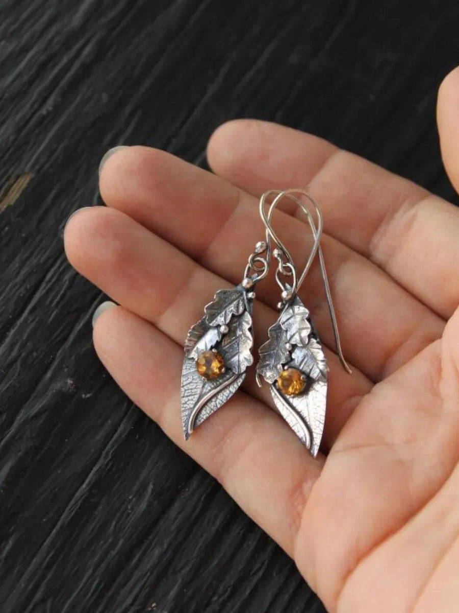 Textured leaf drop earrings with citrine stones in yellow, crafted from alloy.