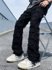 Black distressed slim fit jeans with heavy fraying and ripped details.
