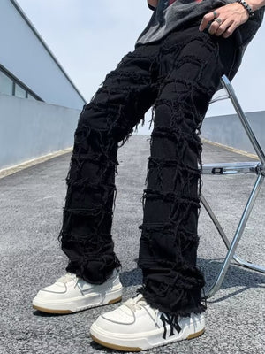 Black distressed slim fit jeans with heavy fraying and ripped details.