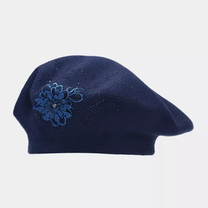 Black hat featuring rhinestone embellishment and floral