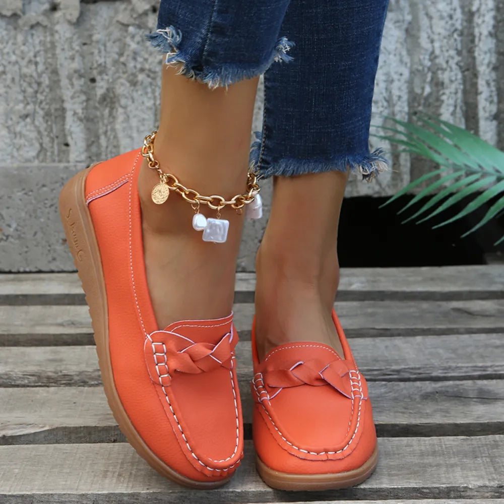 Orange-Red leather loafers with braided detail and white stitching.