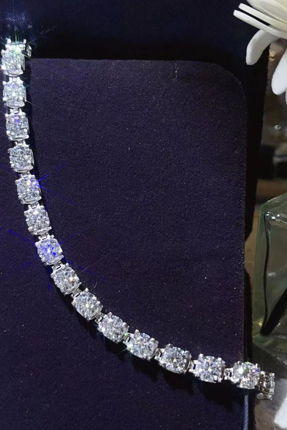Diamond tennis bracelet in platinum with square-cut stones.