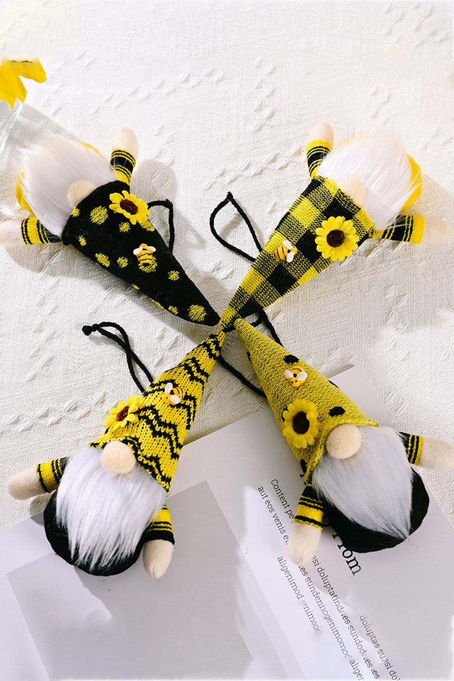 Yellow bee-themed gnome ornaments with sunflowers and plaid patterns.
