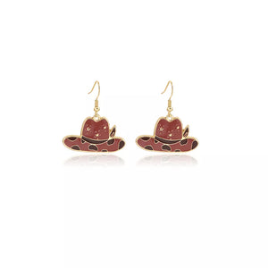 earrings in gold with cow print and dangle