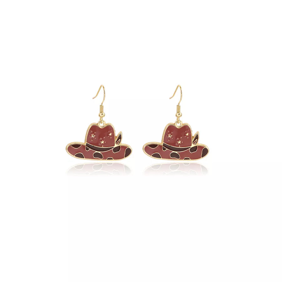 earrings in gold with cow print and dangle