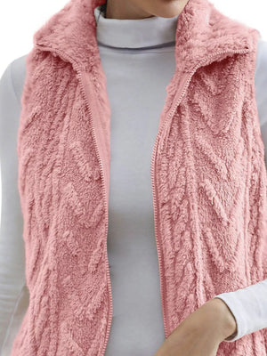 Pink faux fur zip-up vest with chevron texture and a stand-up collar.