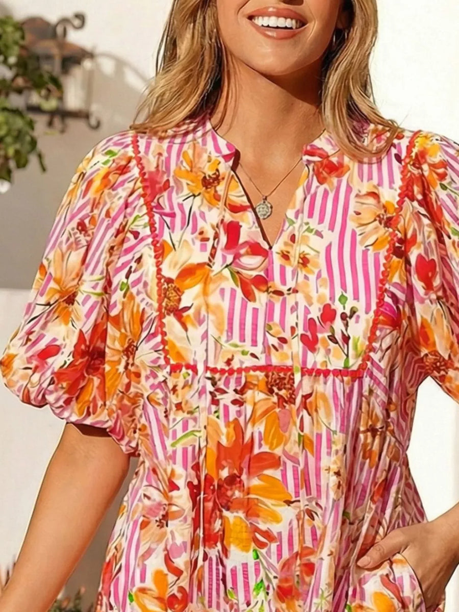 Cotton floral print mini dress with pink stripes, puff sleeves, and pockets.
