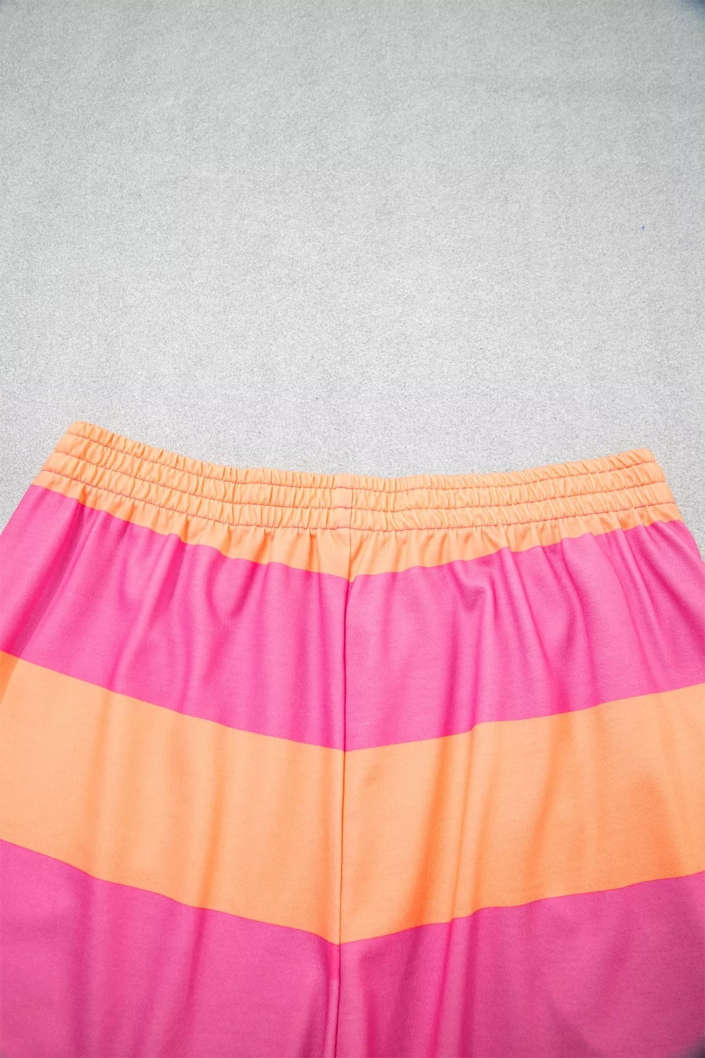 Vibrant striped two-piece set with elastic waistband and drawstring detail.