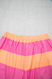 Vibrant striped two-piece set with elastic waistband and drawstring detail.