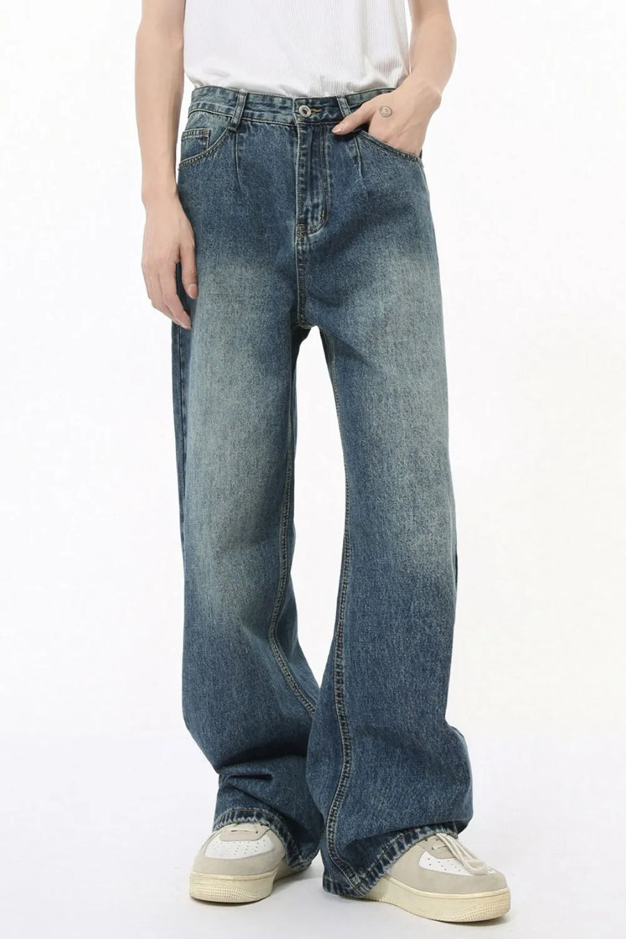 Pleated baggy denim jeans in medium wash with a relaxed fit and wide leg.