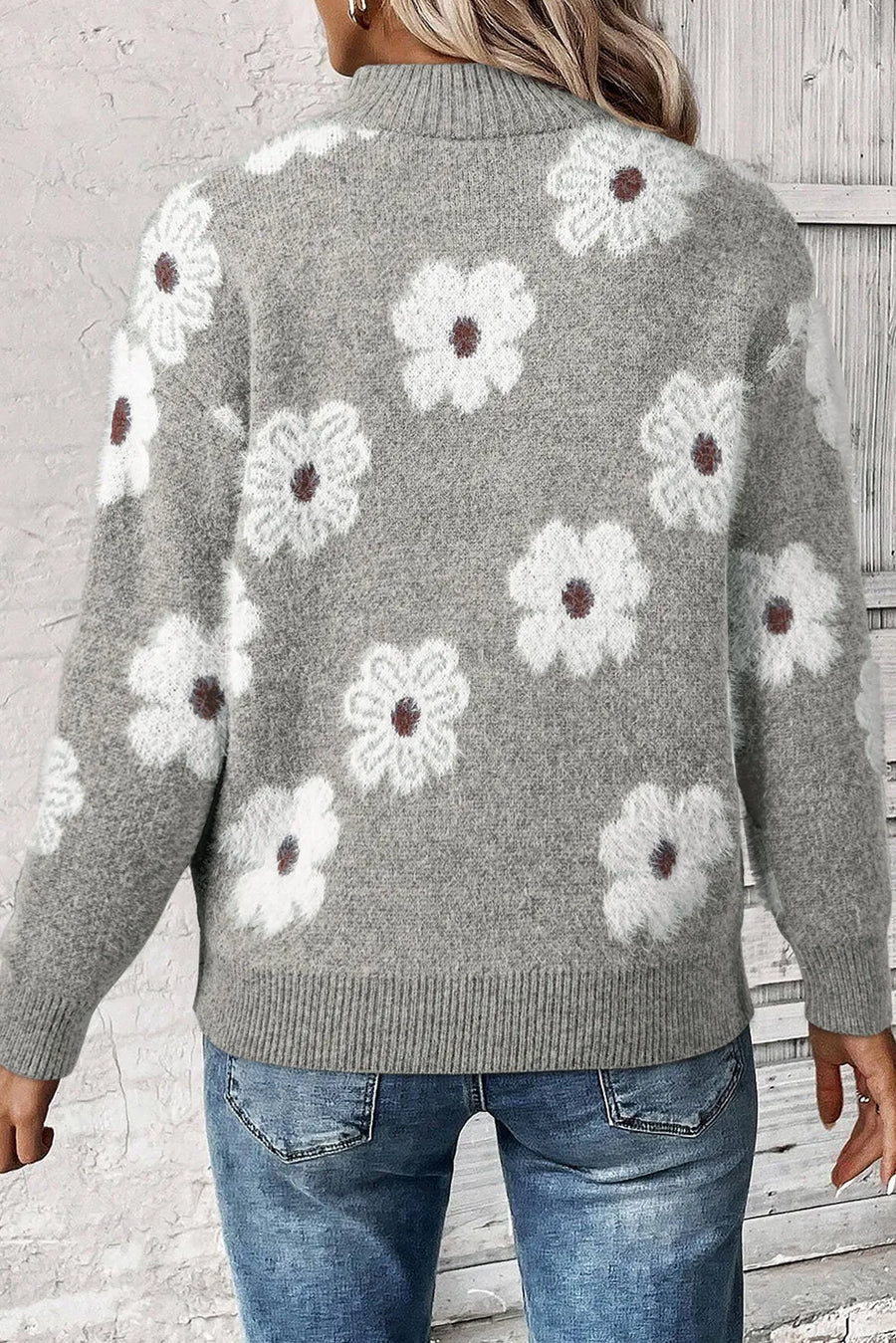 Gray acrylic sweater with white floral intarsia pattern and mock neck.