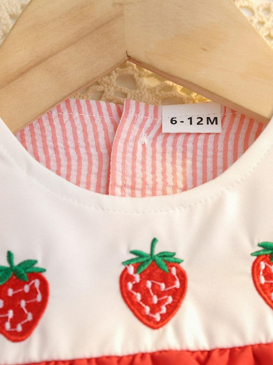 White cotton baby dress with embroidered strawberries and pink seersucker trim.