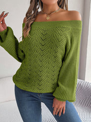 Moss green open-knit off-shoulder sweater with voluminous sleeves and leaf pattern.