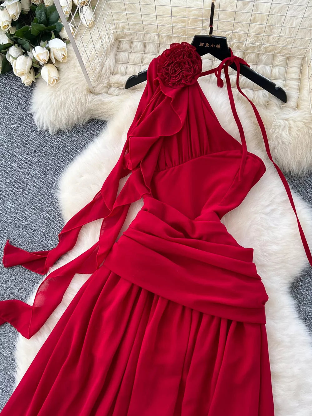 Red floral accent one-shoulder maxi dress with ruffled neckline and tie straps.