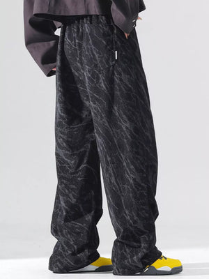 Men's black vintage wide leg sweatpants with abstract pattern and drawstring waist.