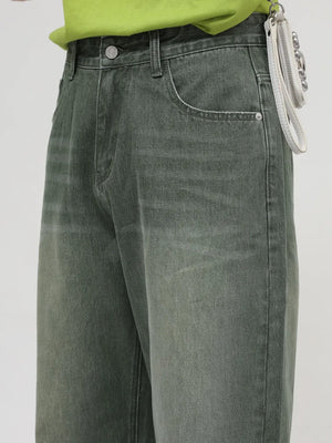 Faded olive wide leg denim jeans with a relaxed fit and visible pocket details.