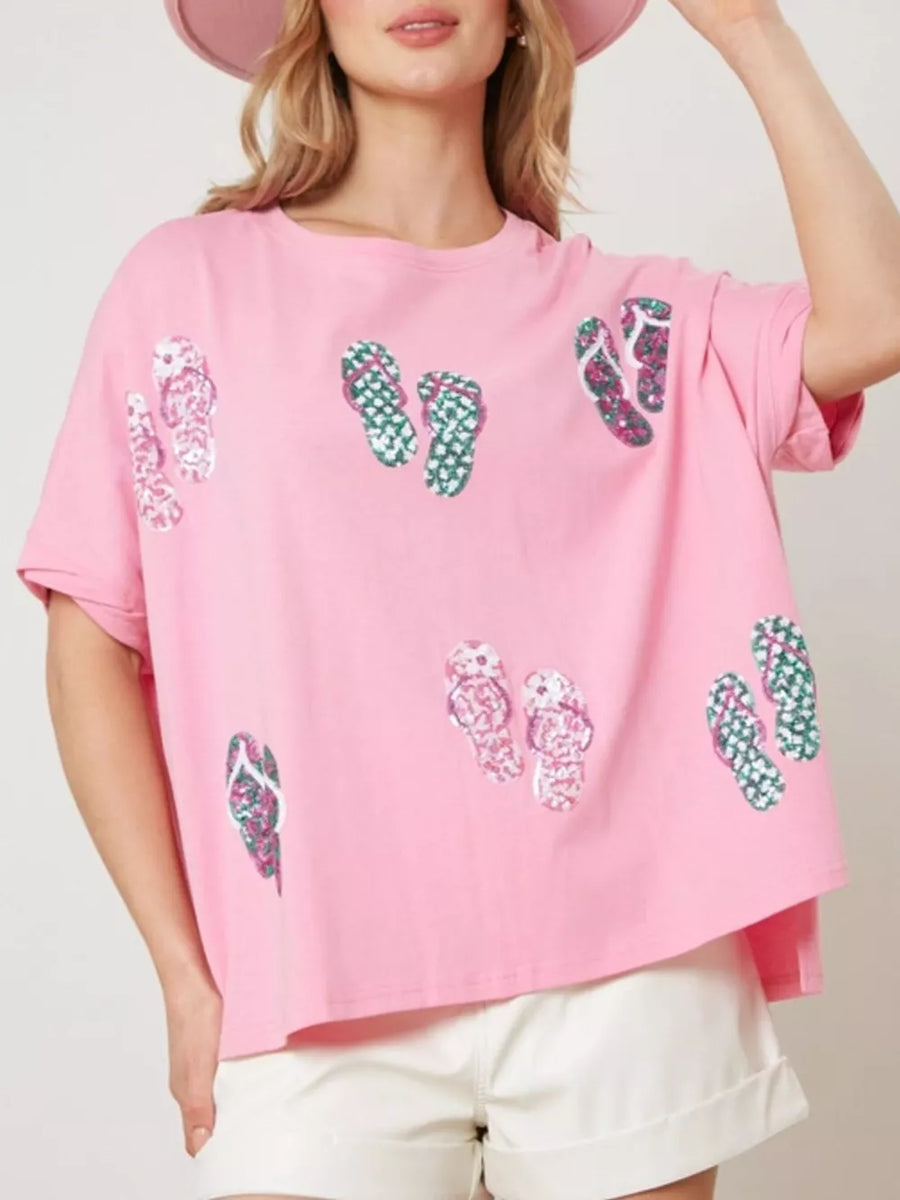 Pink polyester t-shirt with allover flip-flop print and short sleeves.