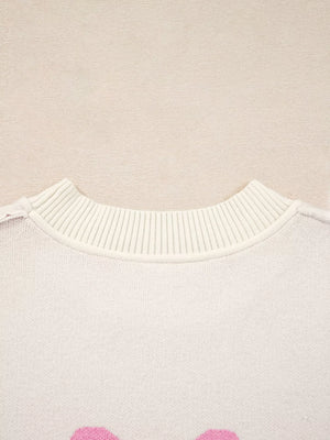 Beige acrylic blend sweater with pink bow print and ribbed crew neck.