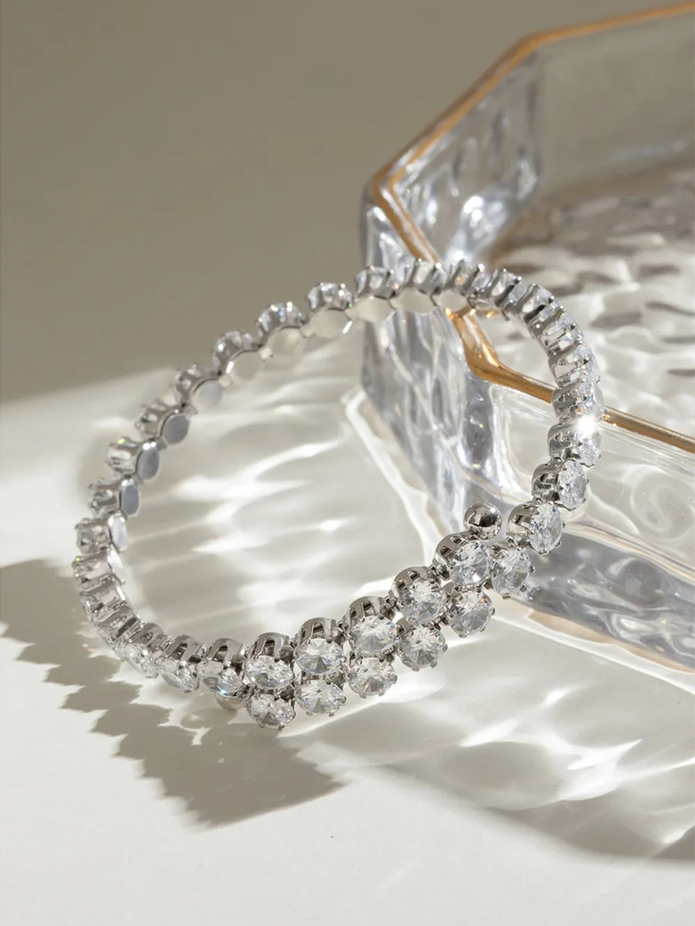 Silver double row pavé bangle bracelet with clear cubic zirconia stones.