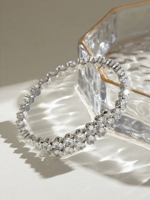 Silver double row pavé bangle bracelet with clear cubic zirconia stones.