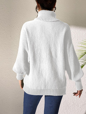 White knit turtleneck sweater with dolman sleeves and ribbed cuffs and hem.