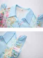 Light blue floral midi dress with ruffle sleeves and button front.