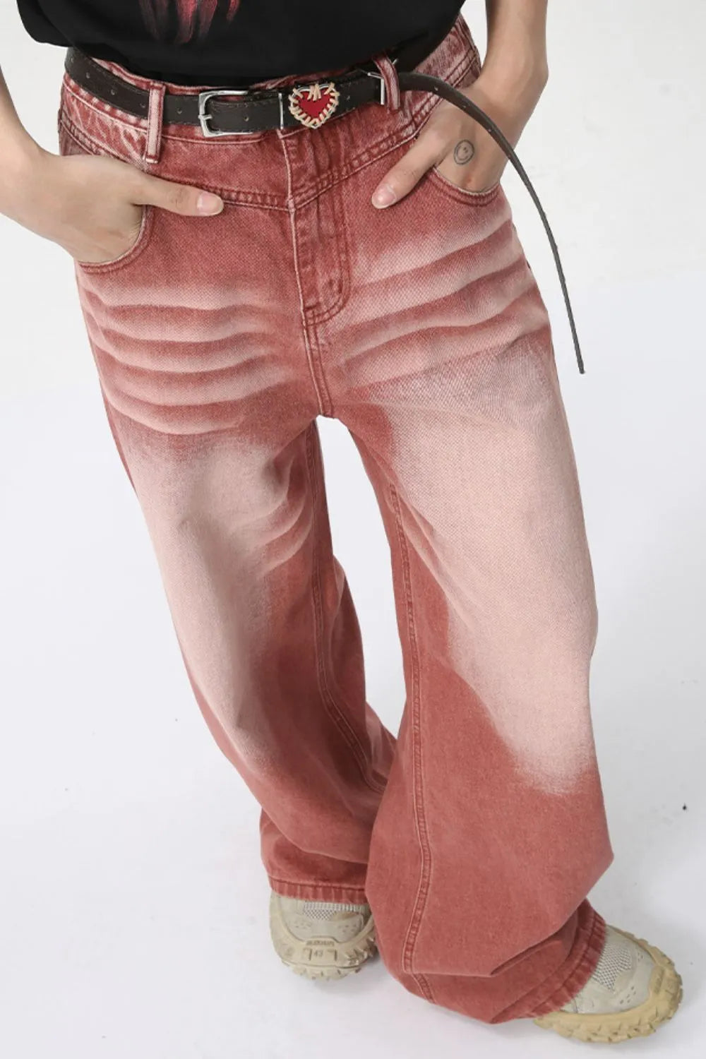 Sunset dip-dye wide leg jeans in rust with a faded effect and a black belt with heart buckle.