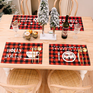 Festive plaid placemats and runner with Christmas designs in red and black.